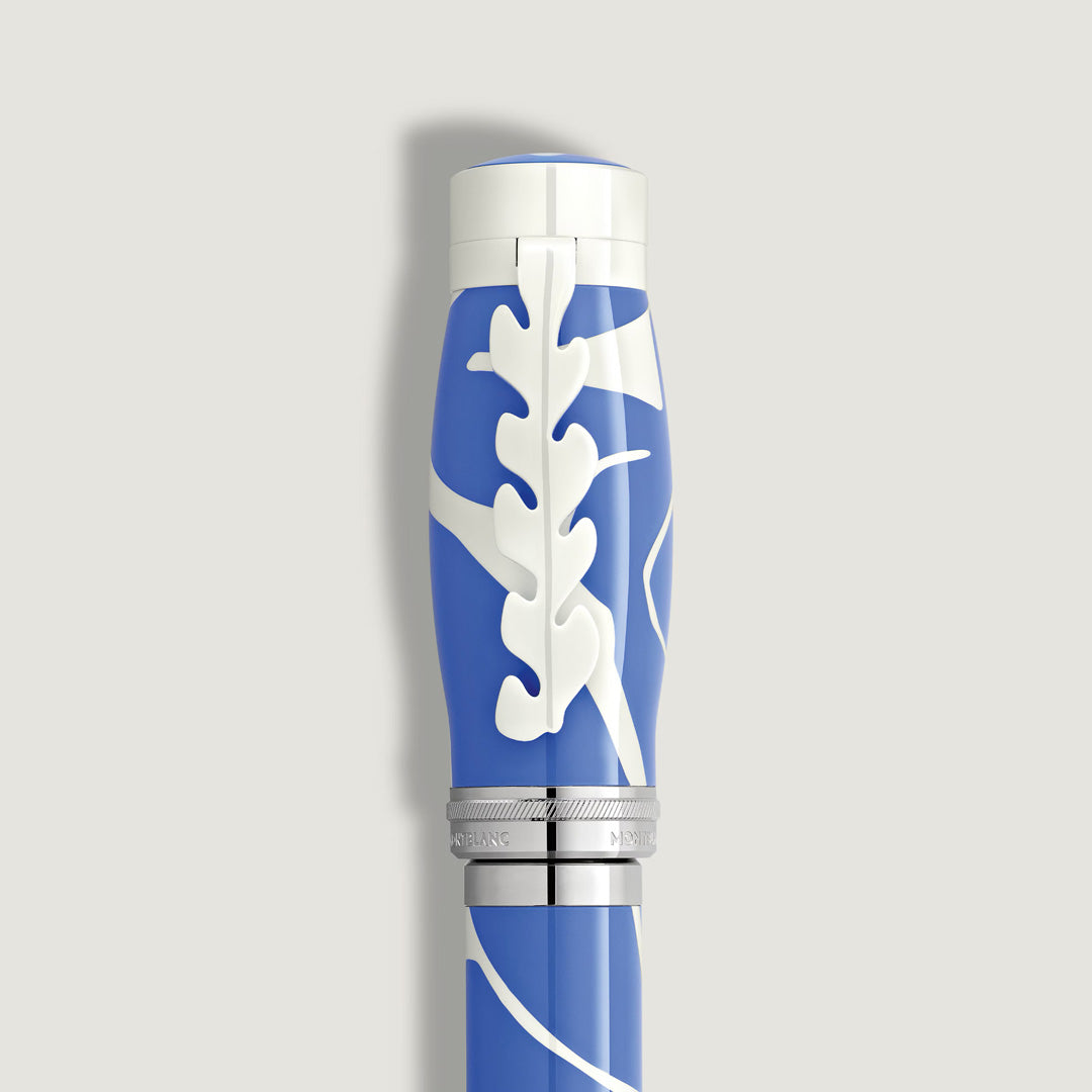 A close-up of the Montblanc Masters of Art Homage to Henri Matisse Limited Edition 4810 Fountain Pen, featuring blue and white design, a silver band, and abstract leaf motifs on the cap, set against a light gray background.