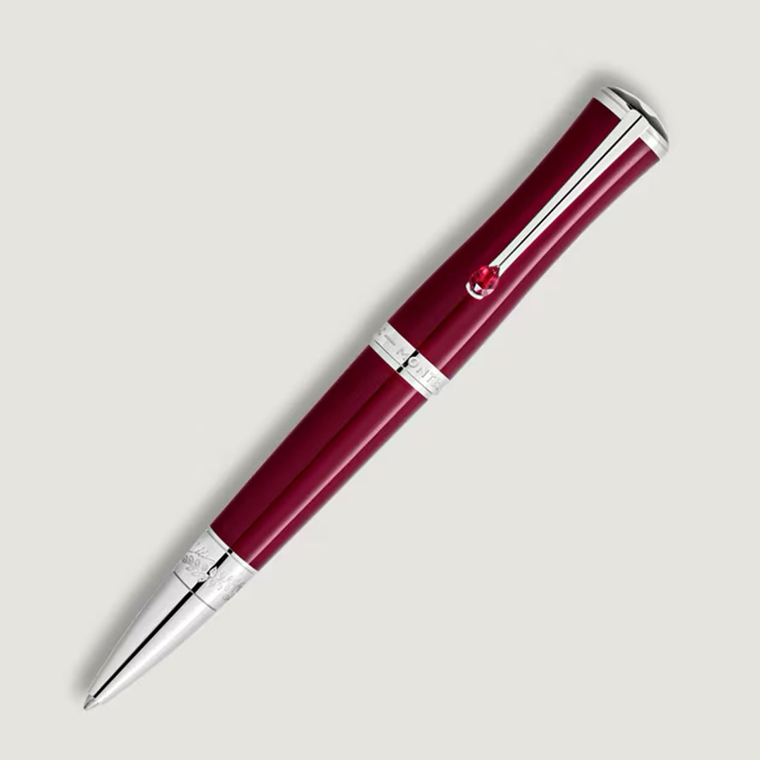 The Montblanc Maria Callas Special Edition Ballpoint Pen features a ruby hue with silver accents and a decorative clip, showcased on a light gray background.