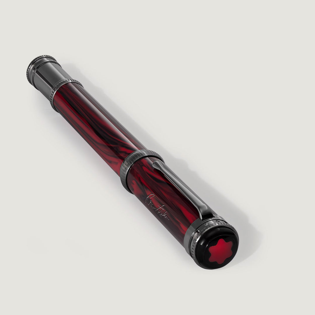 The Montblanc Writers Edition Homage to Bram Stoker Limited Edition Fountain Pen features a marbled deep red and black body, silver accents, a clip, and a red star emblem on the cap, reflecting Dracula's dramatic allure.