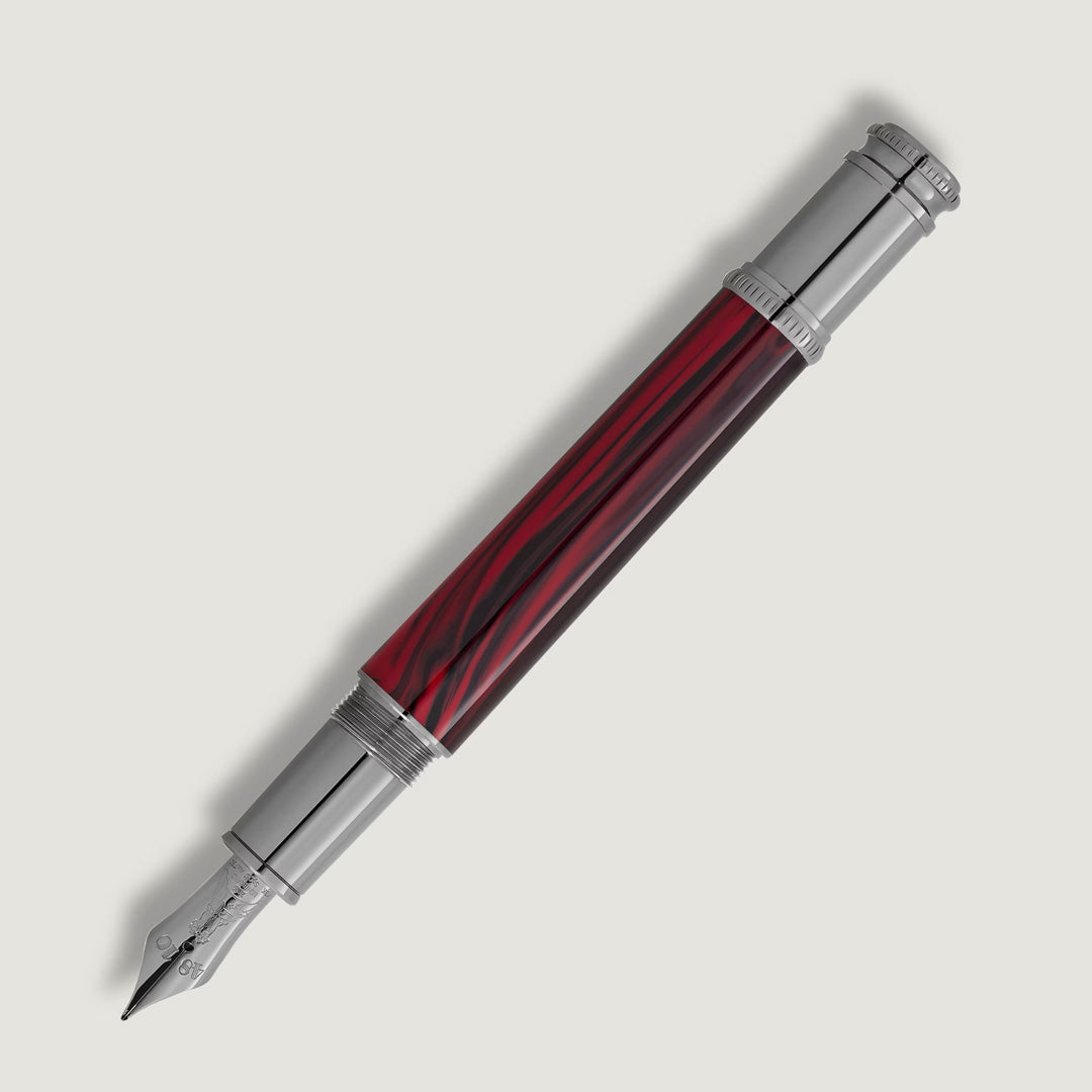 The Montblanc Writers Edition Homage to Bram Stoker Limited Edition Fountain Pen, in silver and red marbled finish with a polished metal cap and nib, is displayed diagonally on a white background.