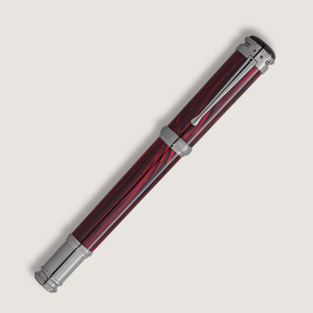 The Montblanc Writers Edition Homage to Bram Stoker Limited Edition Rollerball Pen features a red and black marbled design with silver accents and clip, inspired by Dracula, displayed against a plain white background.