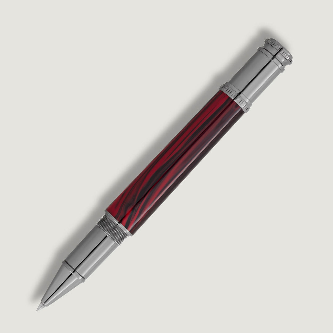 The Montblanc Writers Edition Homage to Bram Stoker Limited Edition Rollerball Pen features a shiny silver cap and tip with a glossy marbled deep red and black barrel, inspired by Dracula, shown diagonally on a plain white background.