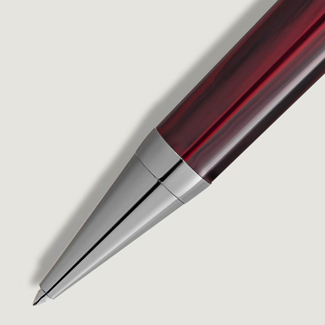 Close-up of the Montblanc Writers Edition Homage to Bram Stoker Limited Edition Ballpoint Pen, featuring a glossy dark red barrel and shiny silver tip, displayed diagonally on a light gray background.