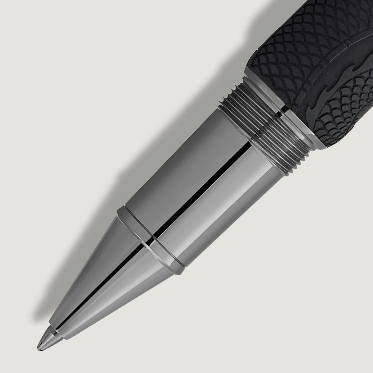Close-up of the silver-toned metal pen tip on a Montblanc Great Characters Bruce Lee Special Edition Rollerball Pen, featuring a textured black grip with a dragon-scale pattern.
