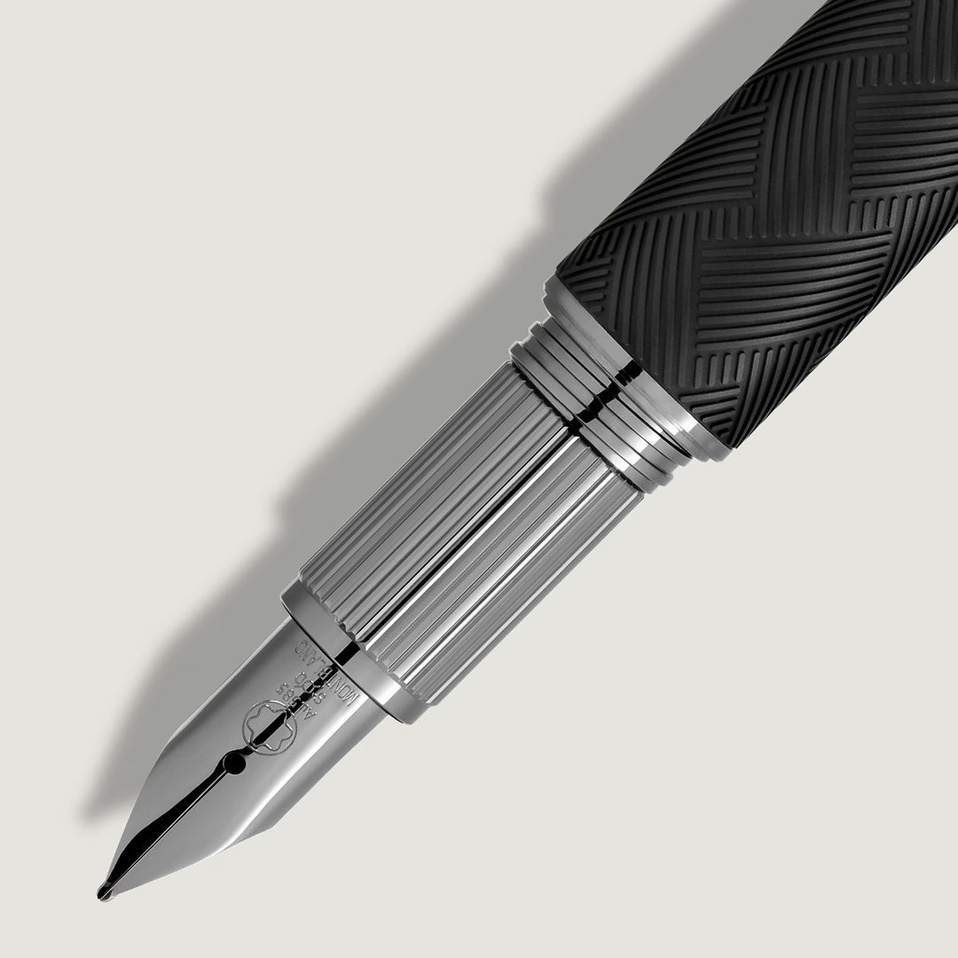 Close-up of the Montblanc StarWalker Extreme Precious Resin Fountain Pen with a black textured grip, shiny silver nib and barrel, and sleek ruthenium-coated fittings, displayed diagonally on a light gray background.
