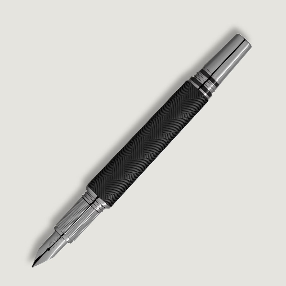 The Montblanc StarWalker Extreme Precious Resin Fountain Pen features a black textured barrel with ruthenium-coated silver accents on the cap and ends, standing out as a premium writing instrument against a white background.