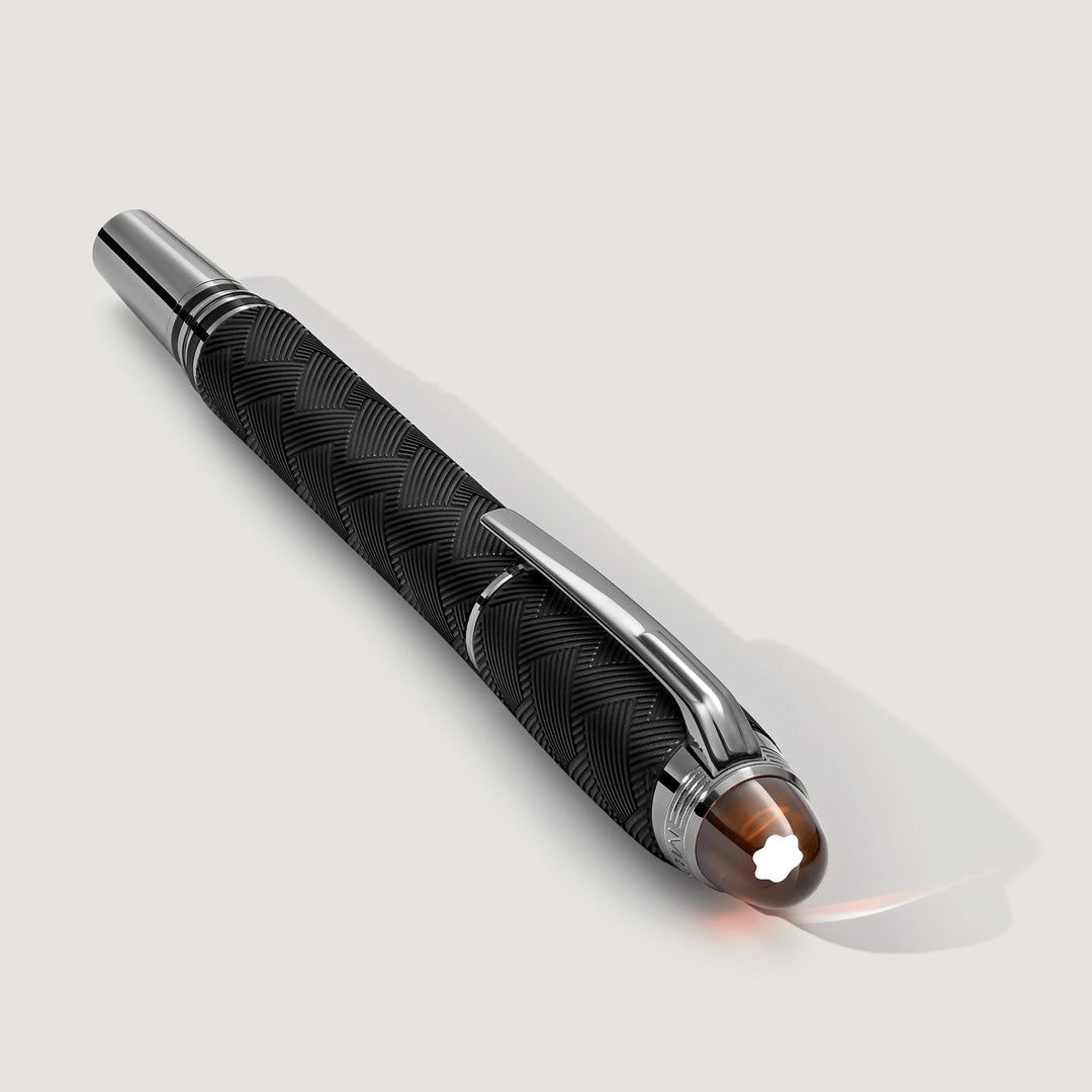 The Montblanc StarWalker Extreme Precious Resin Fountain Pen features a black textured barrel, shiny ruthenium-coated fittings, silver accents, and the iconic white star emblem on its cap end.