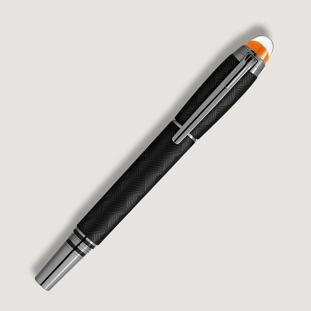 The Montblanc StarWalker Extreme Precious Resin Fineliner Pen features a black, textured barrel with crisscross pattern, ruthenium-coated fittings, silver clip and tip, plus an orange accent at the top—an eye-catching writing instrument.