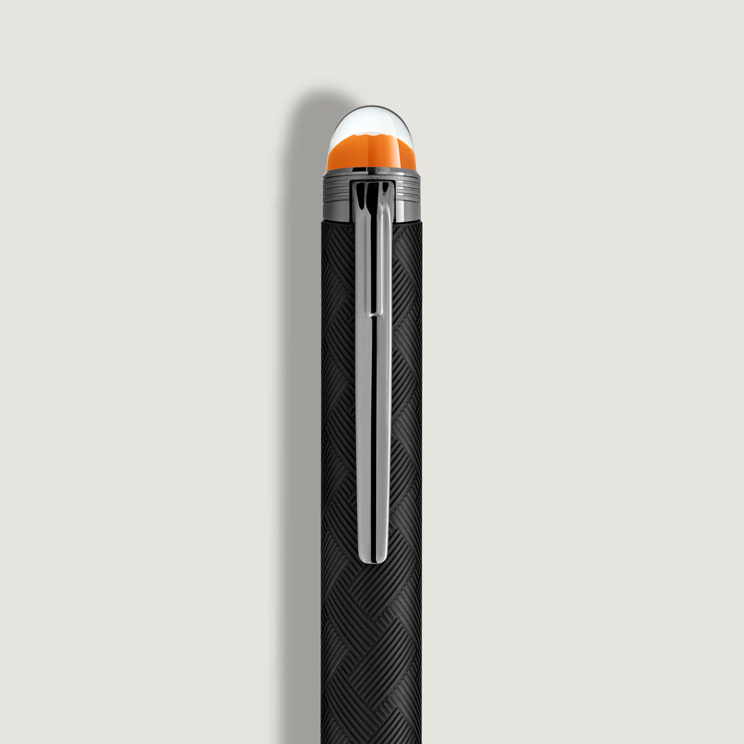 A close-up of the Montblanc StarWalker Extreme Doue Ballpoint Pen shows its black textured body, ruthenium-coated silver clip, and orange-clear cap—a striking luxury writing instrument from Montblanc.