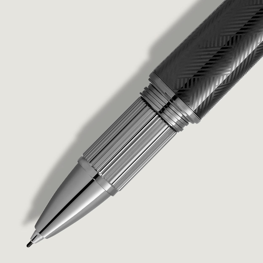A close-up of the Montblanc StarWalker Extreme Metal Fineliner Pen features a textured dark barrel and metallic ruthenium-coated silver grip and tip, casting a soft shadow on a light background.