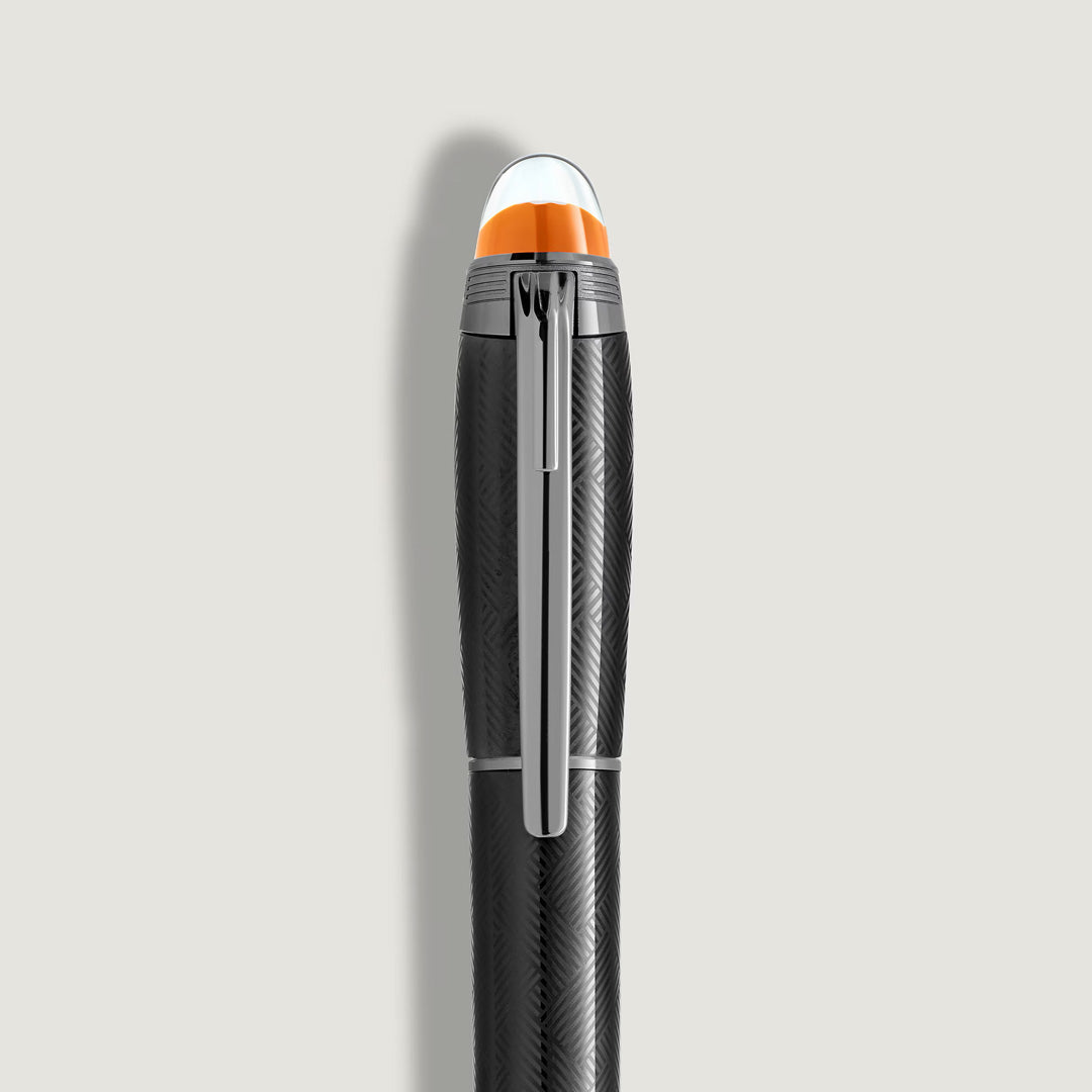 The Montblanc StarWalker Extreme Metal Fineliner Pen features a black, textured barrel with a silver clip and a clear, rounded cap accented by an orange band—an elegant Montblanc writing instrument shown vertically on a light gray background.