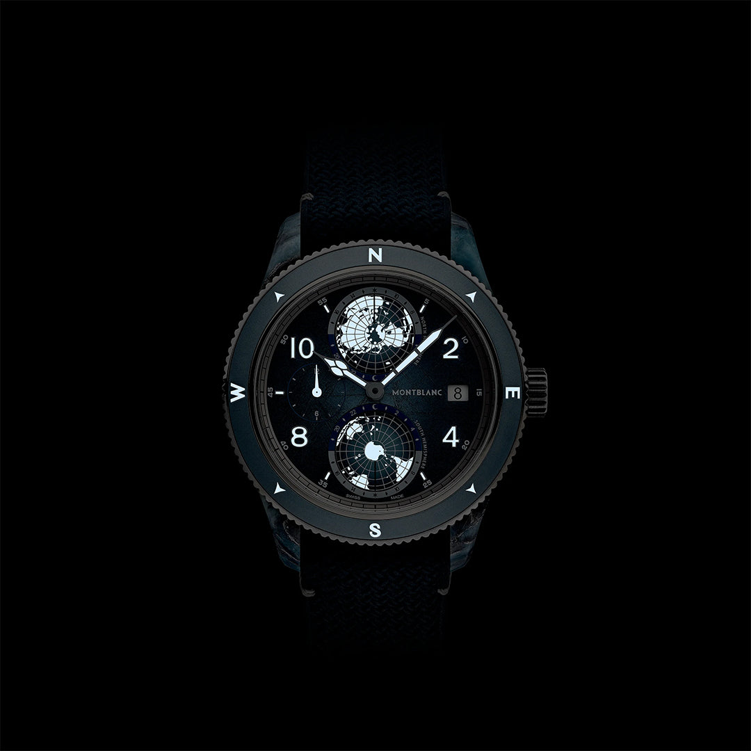 A limited edition Montblanc 1858 Geosphere 0 Oxygen Mount Vison Automatic 43.5mm watch with a dark dial, multiple subdials, date window, compass bezel, and textured black strap—shown against a bold black background.