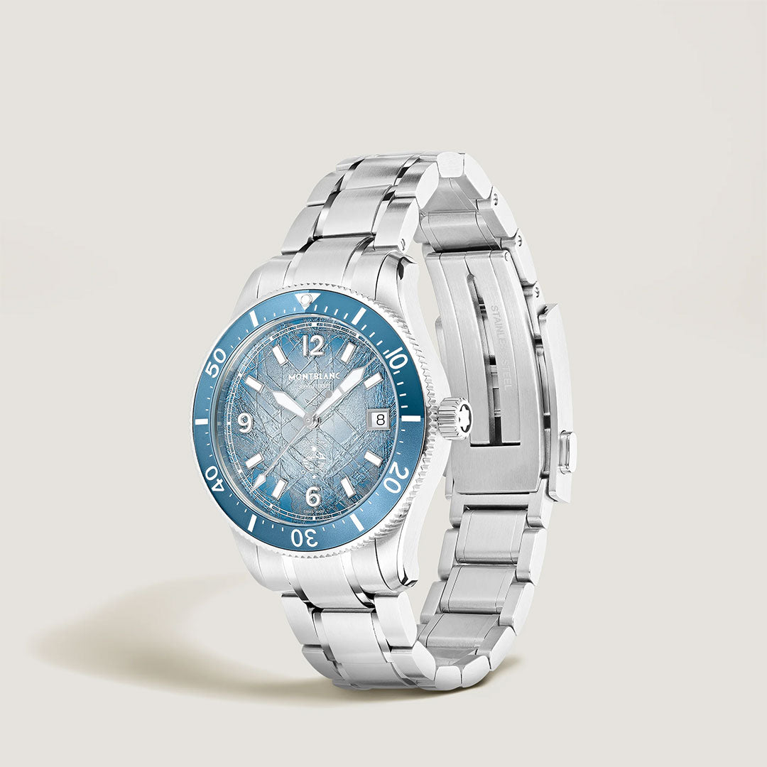 The Montblanc Iced Sea Automatic Date 0 Oxygen 38mm Watch features a stainless steel case, blue bezel, glacier-pattern dial with silver hour markers and date window, shown against a neutral background.