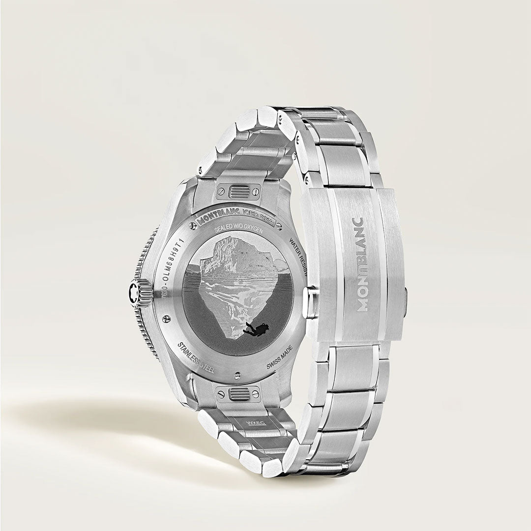 A Montblanc Iced Sea Automatic Date 0 Oxygen 38mm watch is displayed from the back, featuring an engraved mountain design on the case and the Montblanc logo on the metal clasp, set against a neutral backdrop.