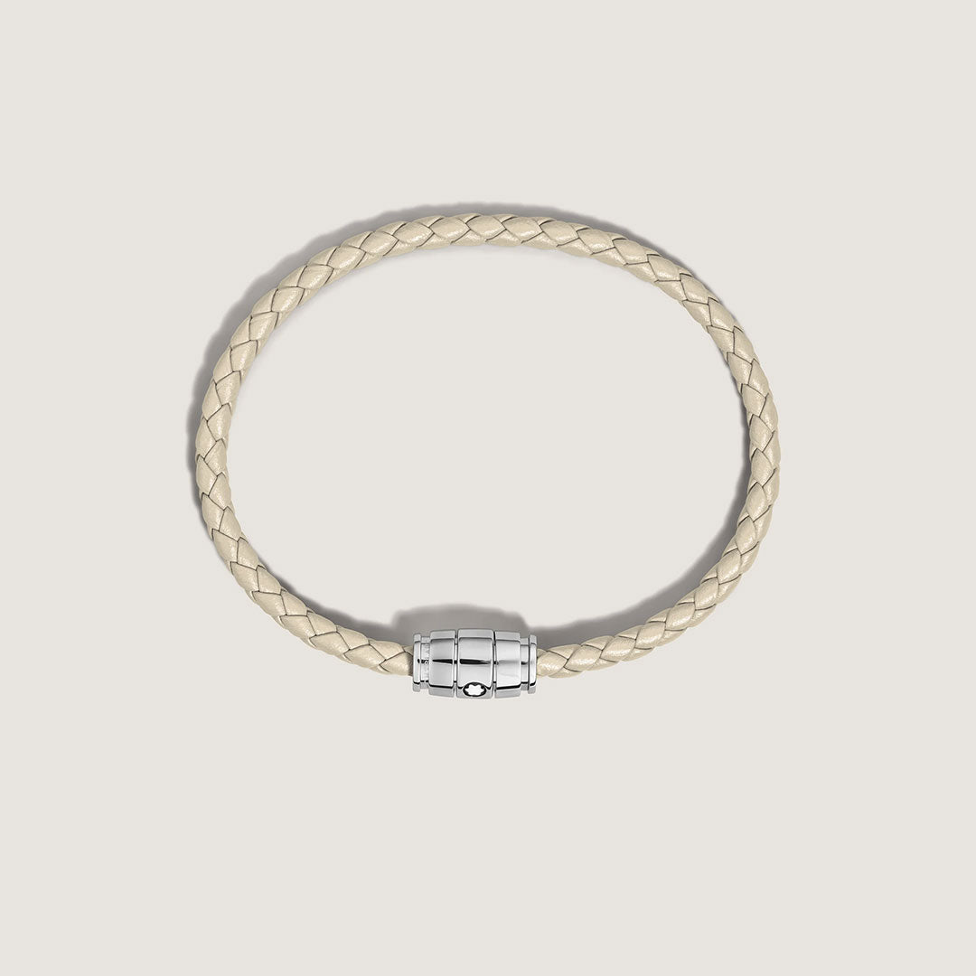 The Montblanc Meisterstuck 3 Rings Cloudy Beige Leather Bracelet features a braided leather design and a shiny silver magnetic clasp, showcased against a plain off-white background.