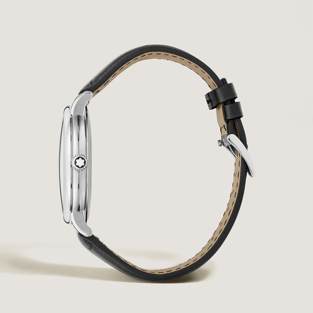 A side view of the Montblanc Star Legacy Automatic Date 42mm Watch by Montblanc, featuring a silver case, anthracite dial, black leather strap, thin profile, and buckle closure against a light background.