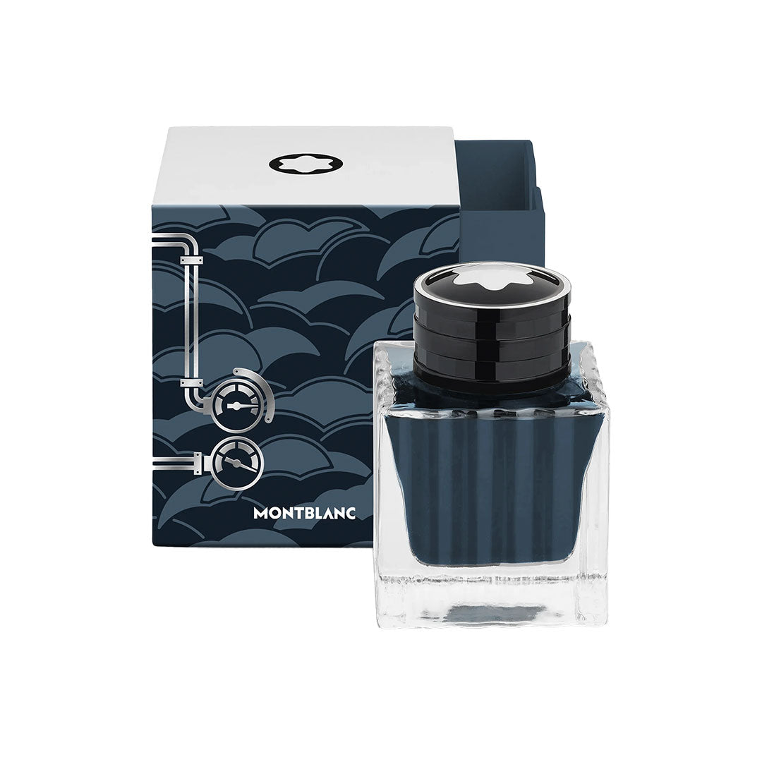 A square 50ml Montblanc Meisterstuck Around the World in 80 Days Coal Blue Ink bottle sits before a decorative blue wave-patterned box with white accents, marking it as a special edition.