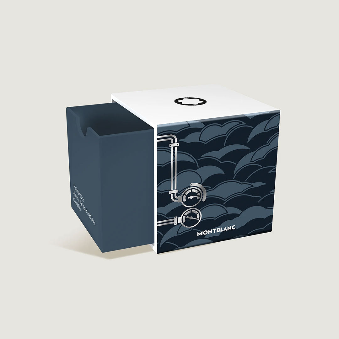 The Montblanc Meisterstuck Around the World in 80 Days Coal Blue 50ml Ink comes in a square box with a white lid and Montblanc emblem, featuring dark blue wave patterns, industrial pipe graphics, and a side cutout—Special Edition packaging.