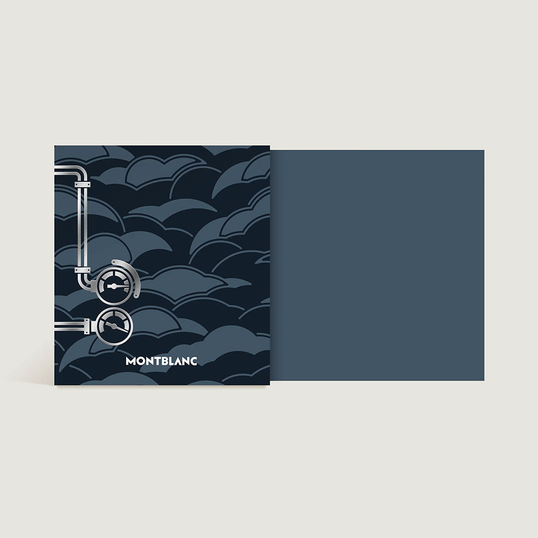 A square card features a dark blue, cloud-like pattern with partial pipe and gauge illustrations on the left. "Montblanc" appears at the bottom, referencing the Montblanc Meisterstück Around the World in 80 Days Coal Blue 50ml Ink bottle.