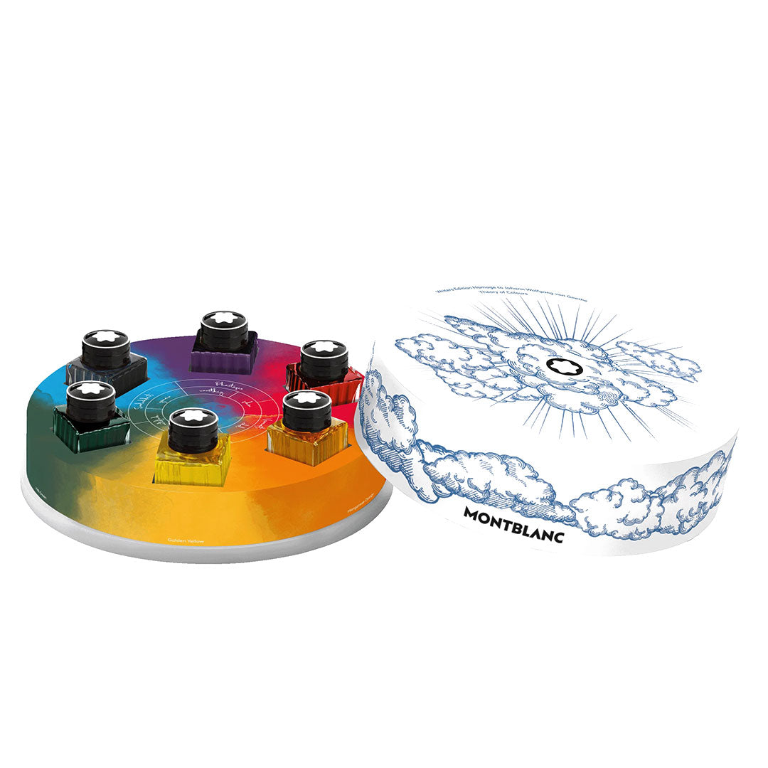 Six Montblanc Writers Edition Homage to Johann Wolfgang von Goethe 30ml ink bottles, arranged on a circular rainbow-gradient base beside a white round box with sky and cloud art and the Montblanc logo at center.