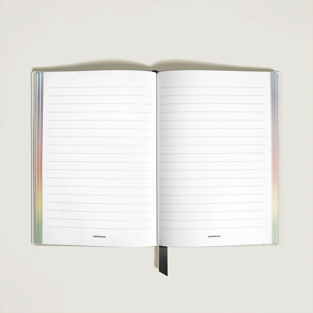 The Montblanc Writers Edition Homage to Johann Wolfgang von Goethe White Lined Pages Medium Notebook, weighing 460g, features lined pages with a black ribbon bookmark, pastel gradient edges, minimal text at the bottom center, and spacious dimensions for writing.