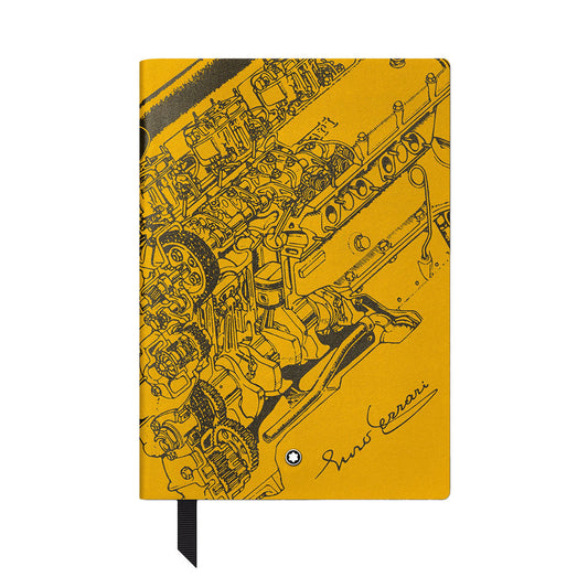 The Montblanc Great Characters Enzo Ferrari Giallo Modena #146 Small Notebook features a detailed black engine line drawing and "Enzo Ferrari" signature on the cover, with a black ribbon bookmark and lined pages.