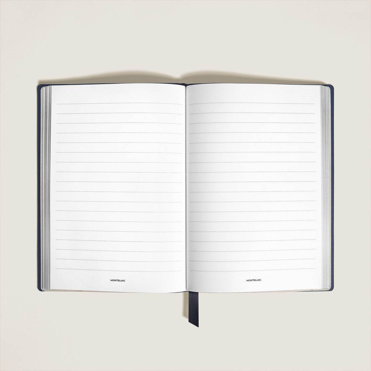 Open blue Montblanc Notebook Medium Saffiano Leather Blue - Lined Pages with lined pages and a ribbon bookmark.