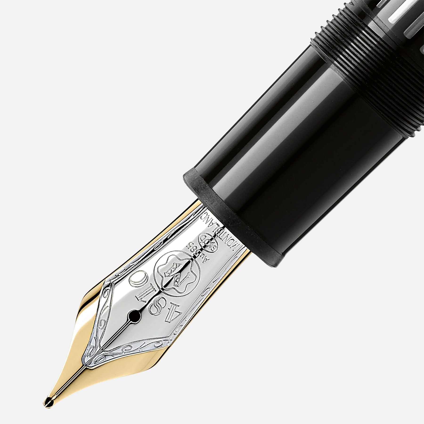 Close-up of the Montblanc Meisterstuck Gold-Coated Le Grand Fountain Pen nib with intricate gold and silver engravings. The glossy black barrel, featuring a textured grip section, highlights the elegant design and craftsmanship of this luxurious writing instrument by Montblanc.