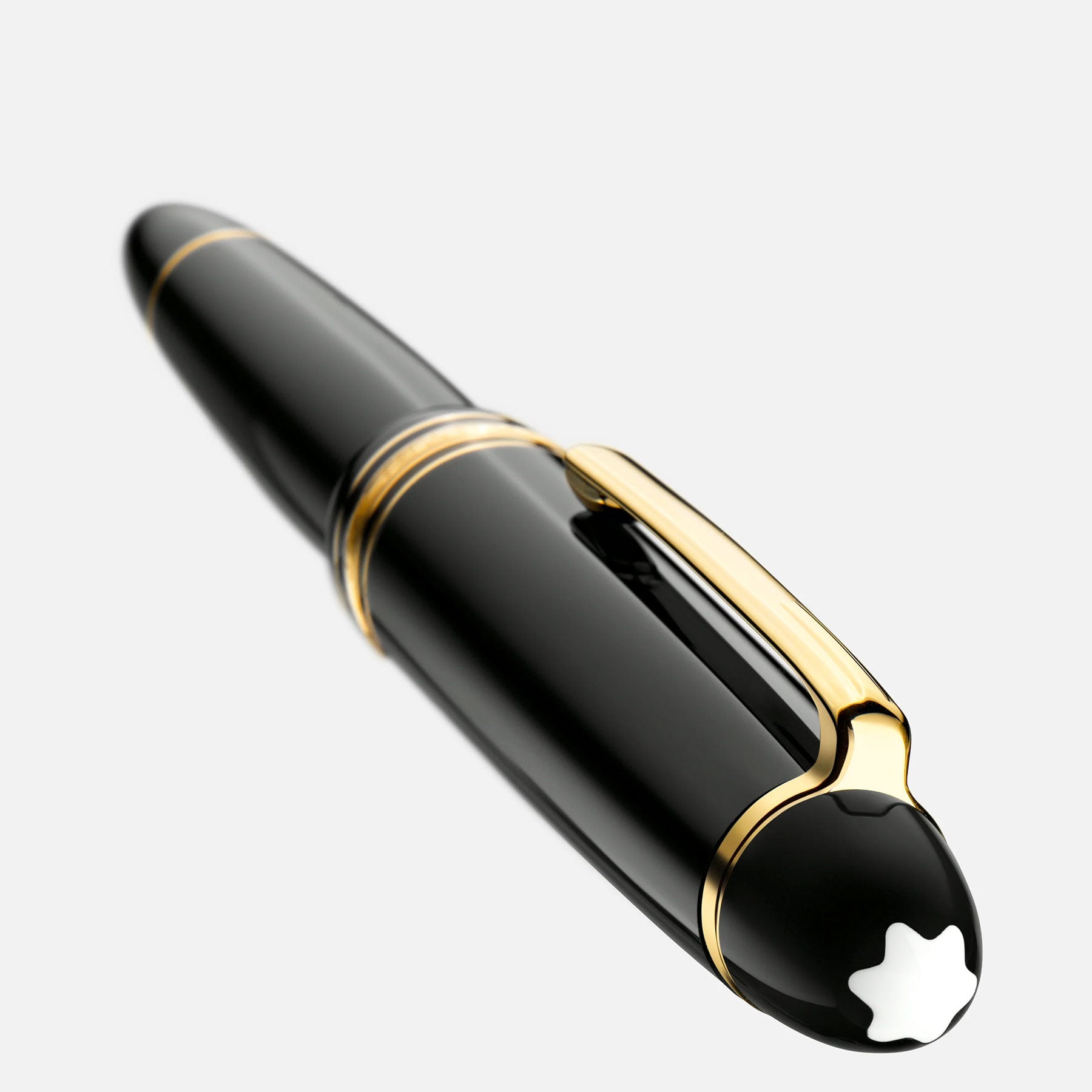 A sleek black Montblanc Meisterstück Gold-Coated Le Grand Fountain Pen with gold nib and accents, featuring a prominent white star-shaped Montblanc emblem on the cap, set against a plain white background.
