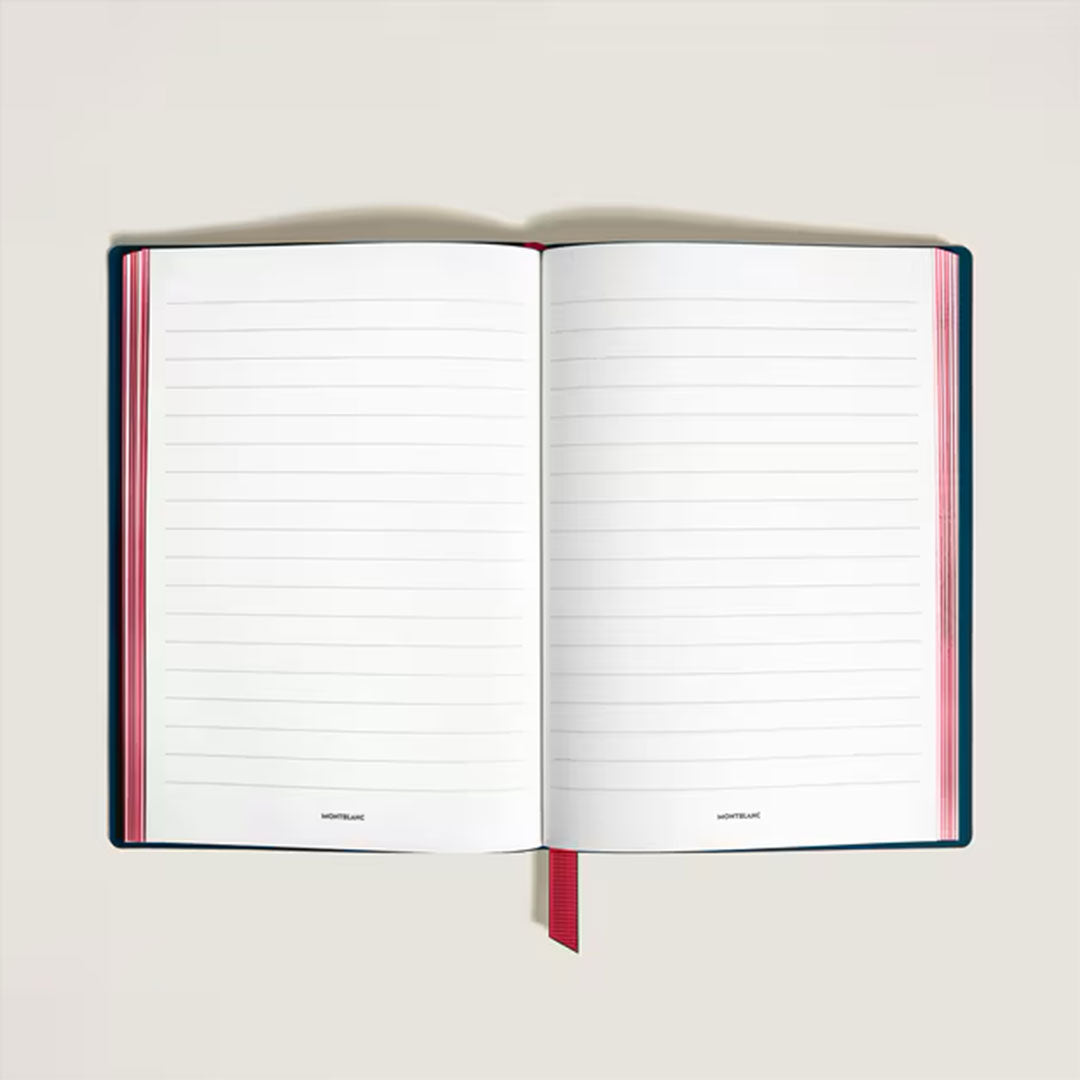 The Montblanc Meisterstück Romeo and Juliet Medium Notebook features a black leather cover, red ribbon bookmark, lined pages with "NOTEBOOK" at the bottom, and is handcrafted in Italy. Photographed from above on a light surface.