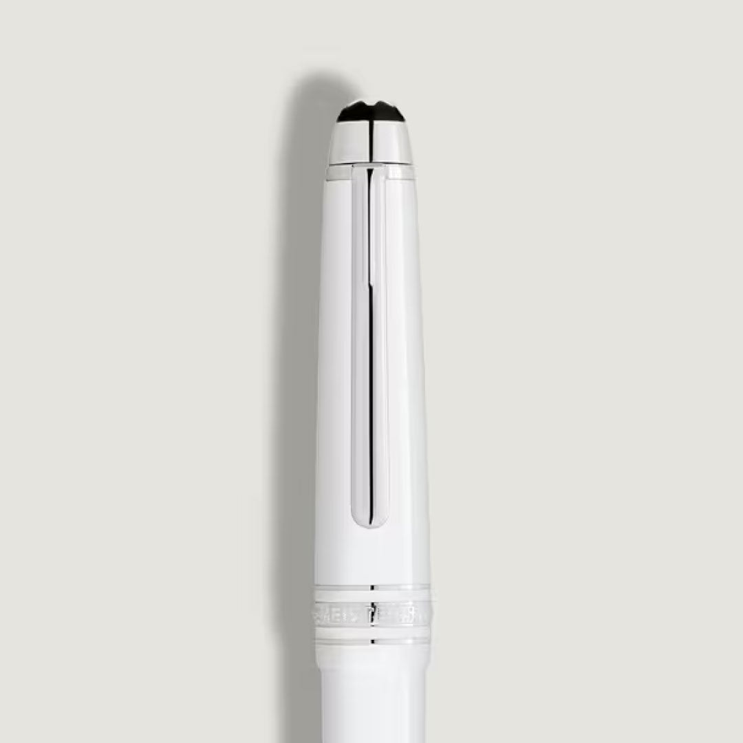 A close-up of the Montblanc Meisterstuck White Classique Fountain Pen M, featuring white precious resin with silver accents, is displayed vertically against a plain light gray background.