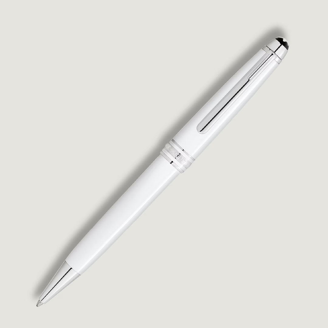 A Montblanc Meisterstuck White Classique Ballpoint Pen by Montblanc is placed diagonally on a light gray background.