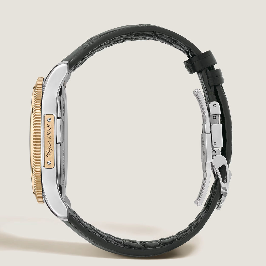 A luxury Montblanc Minerva The Unveiled Crownless Manual Winding 41.5mm watch is displayed in a side view, showcasing a rose gold bezel, a silver case engraved with "Dolphin 1883," and a black leather strap finished with a metal clasp—an elegant Montblanc timepiece that epitomizes sophistication.