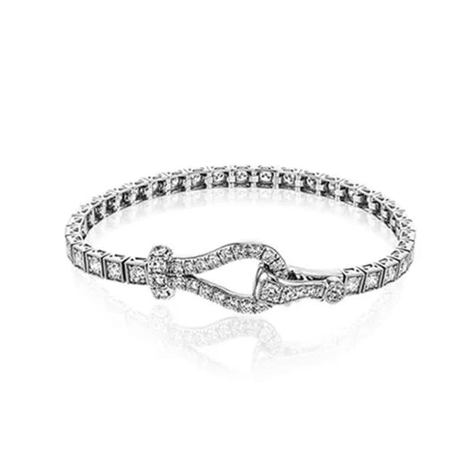 The Simon G. 18K White Gold Diamond Buckle Bracelet is a sophisticated piece, showcasing small square-shaped stones and a unique buckle clasp in the center, elegantly displayed against a plain white background.