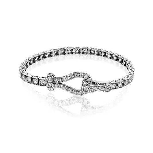 A bracelet from Simon G, crafted in 18K white and rose gold, is embellished with small, sparkling white diamonds and boasts an elegant interlocking buckle clasp design, set against a pristine white background.