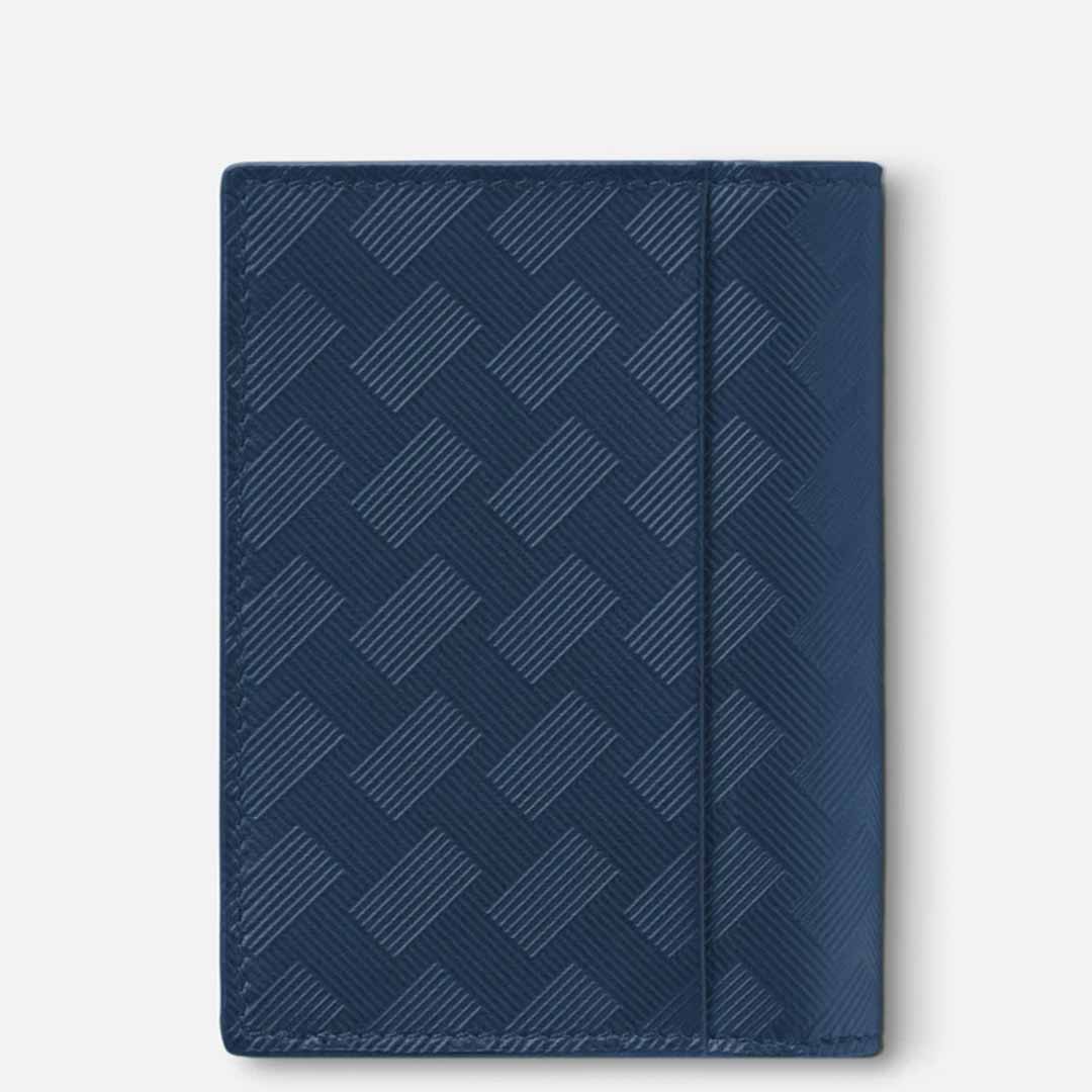 A blue textured notebook with a geometric pattern on the cover sits against a plain white background. Accompanying it is the Montblanc Extreme 3.0 4cc Leather Blue Card Holder from Montblanc, featuring credit card slots that seamlessly blend style and functionality.