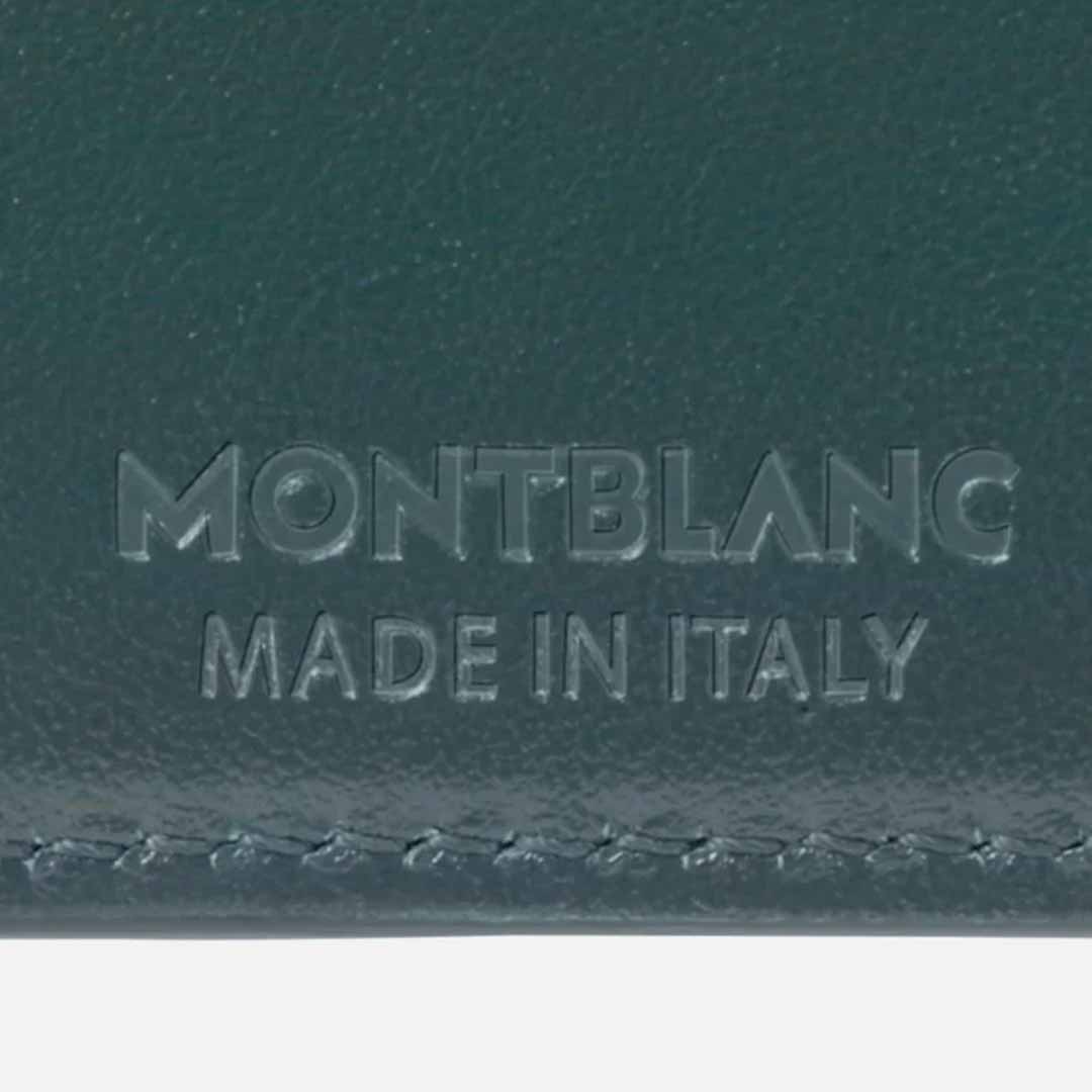 Close-up of a Montblanc Meisterstück 6cc Leather Wallet crafted from premium British green leather, featuring embossed text reading "Montblanc Made in Italy," part of an exclusive capsule collection.