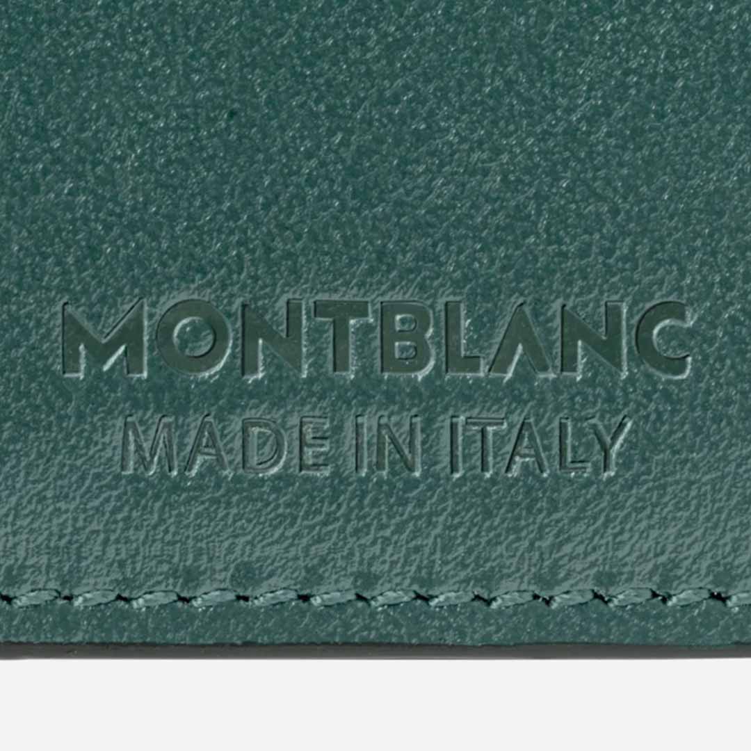Close-up of the British green textured leather featuring the embossed text "MONTBLANC MADE IN ITALY," part of Montblanc's 100 Years capsule collection. The edge displays intricate stitching detail, showcasing the exquisite craftsmanship of the Montblanc Meisterstuck 4cc Leather Card Holder.