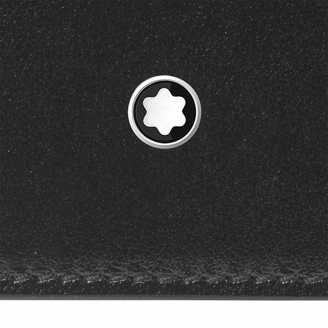 Close-up of the Montblanc Meisterstück 6cc Leather Card Holder, crafted from premium black leather and featuring a star-like white emblem encircled by silver. The texture of the leather is visible, highlighting its quality and stitching details, embodying the elegance of Montblanc.