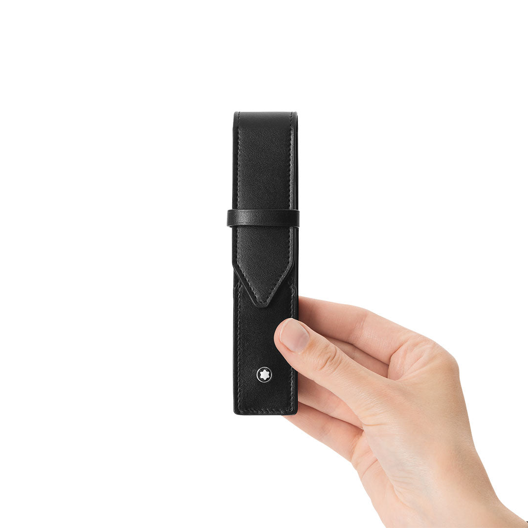 A hand holds a Montblanc Meisterstuck 1-Pen Leather Pouch by Montblanc, featuring black leather, a flap closure, and a small silver emblem near the bottom, set against a plain white background.
