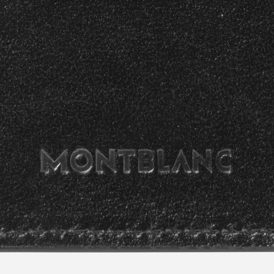 Close-up of the black leather from the Montblanc Meisterstück 3-Pen Leather Pouch, adorned with the embossed word "Montblanc" in the center. The luxurious texture of this handcrafted pouch is highlighted, showcasing detailed stitching along the bottom edge and featuring the iconic Montblanc emblem.
