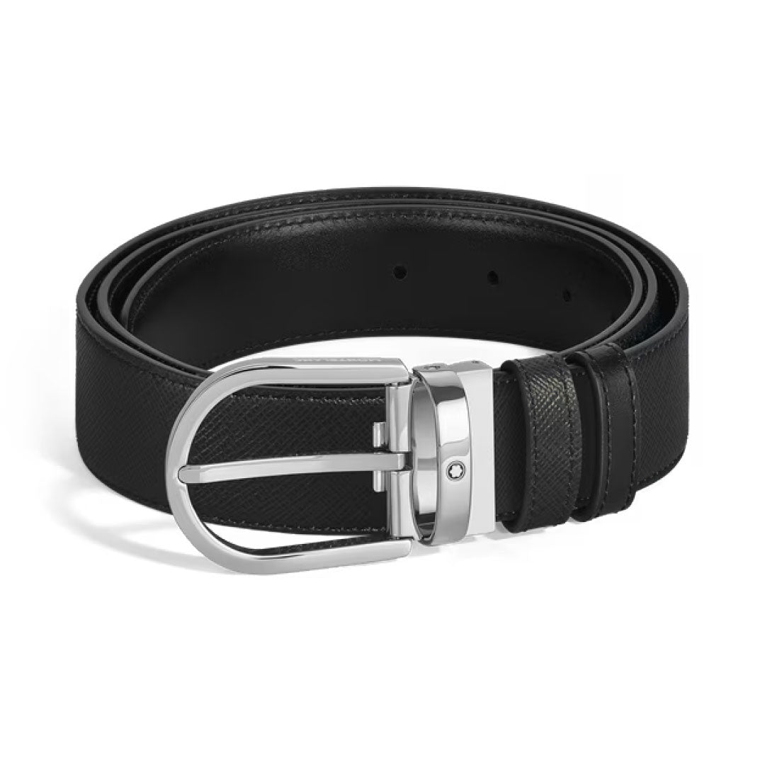 The Montblanc Horseshoe Buckle 35mm Reversible Leather Belt features black saffiano-printed leather with a textured finish and a shiny silver buckle, displayed coiled on a white background.