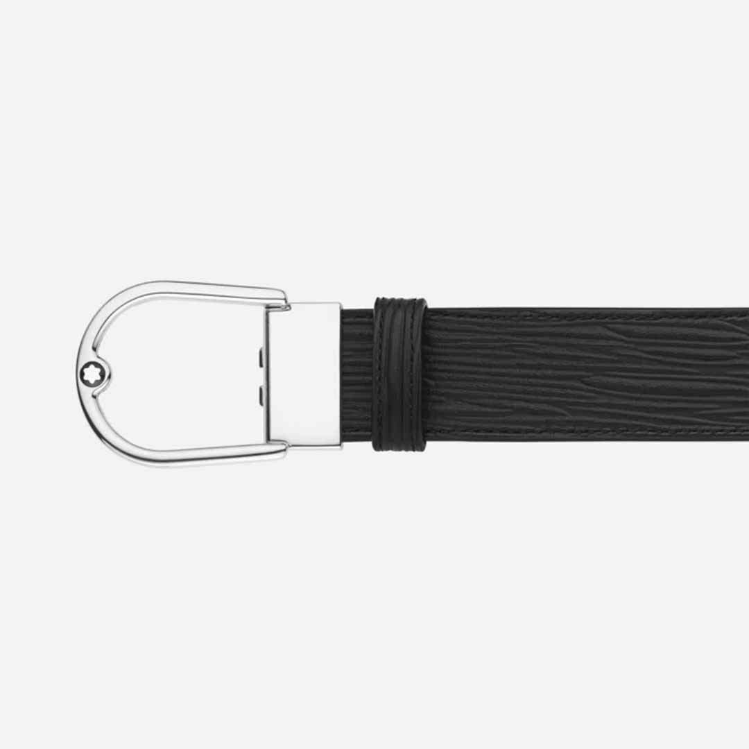 The Montblanc Horseshoe 35mm Reversible Leather Belt is a black leather accessory with a textured pattern and a minimalist silver horseshoe buckle, showcased against a plain white background.