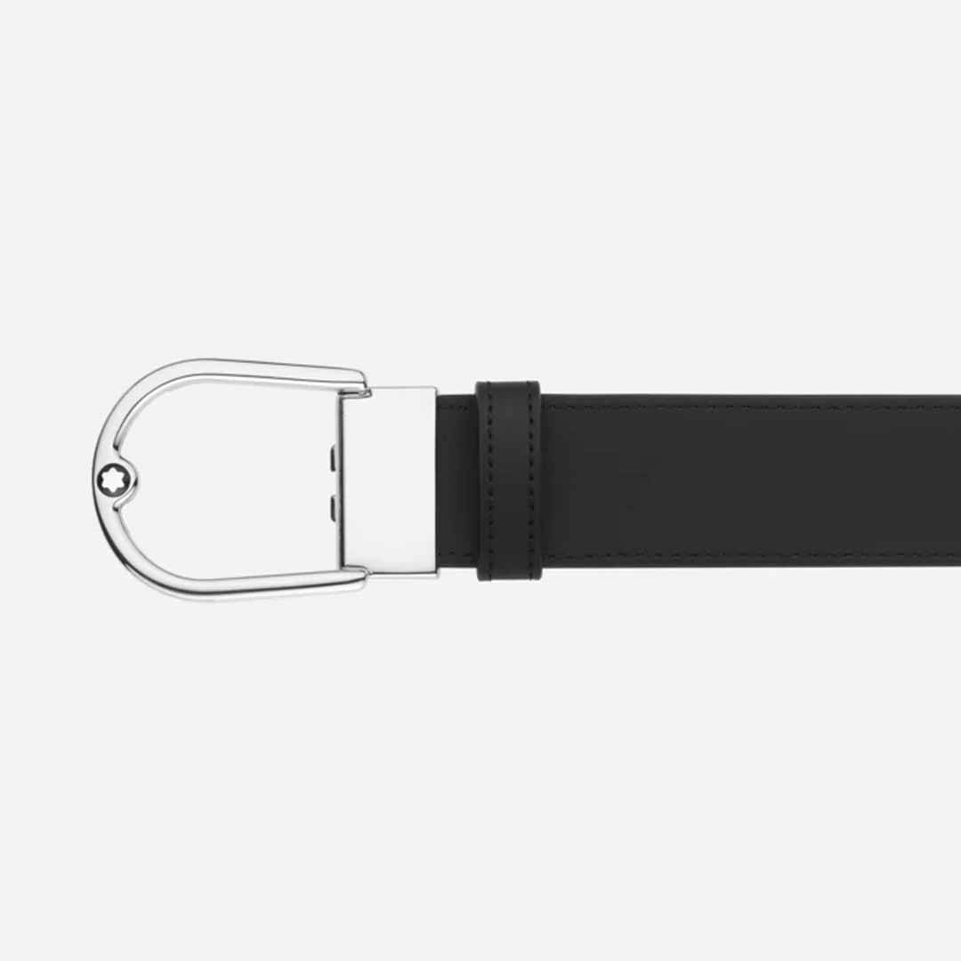 Introducing the Montblanc Horseshoe 35mm Reversible Leather Belt, a stylish accessory with a sleek black leather finish. It features a unique, rounded shiny silver horseshoe buckle adorned with three visible adjustment holes and proudly displays the iconic Montblanc emblem on the left side.
