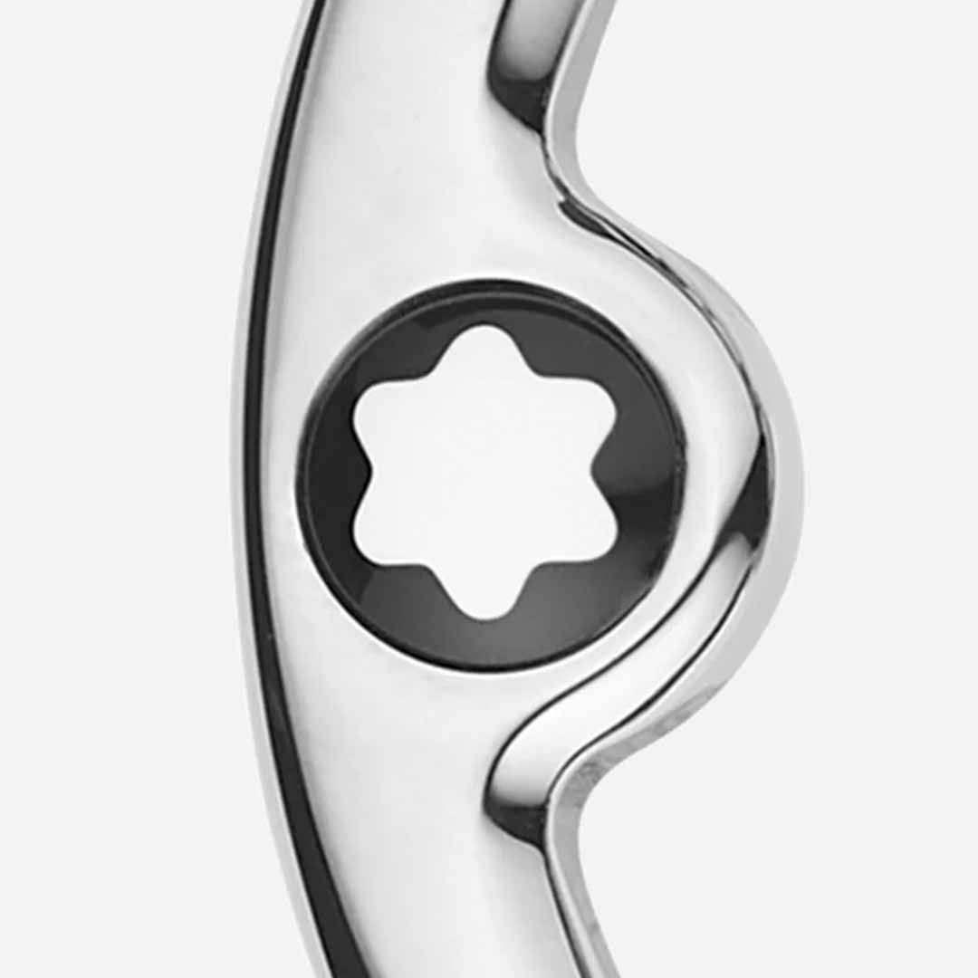 Close-up image of the Montblanc Horseshoe 35mm Reversible Leather Belt's shiny, curved metal buckle, which includes a central black circular area with a white, star-shaped indentation. The background is plain white.