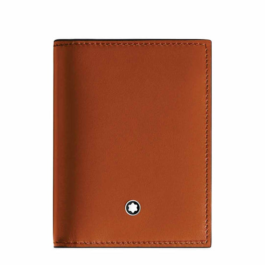 A Montblanc Meisterstuck 4cc Leather Card Holder, crafted in brown leather and styled after a classic Montblanc design, is showcased against a white backdrop. It boasts a smooth finish with a subtle, round emblem of a white star inside a black circle on the front. The card holder is closed with meticulous stitching along its edges.