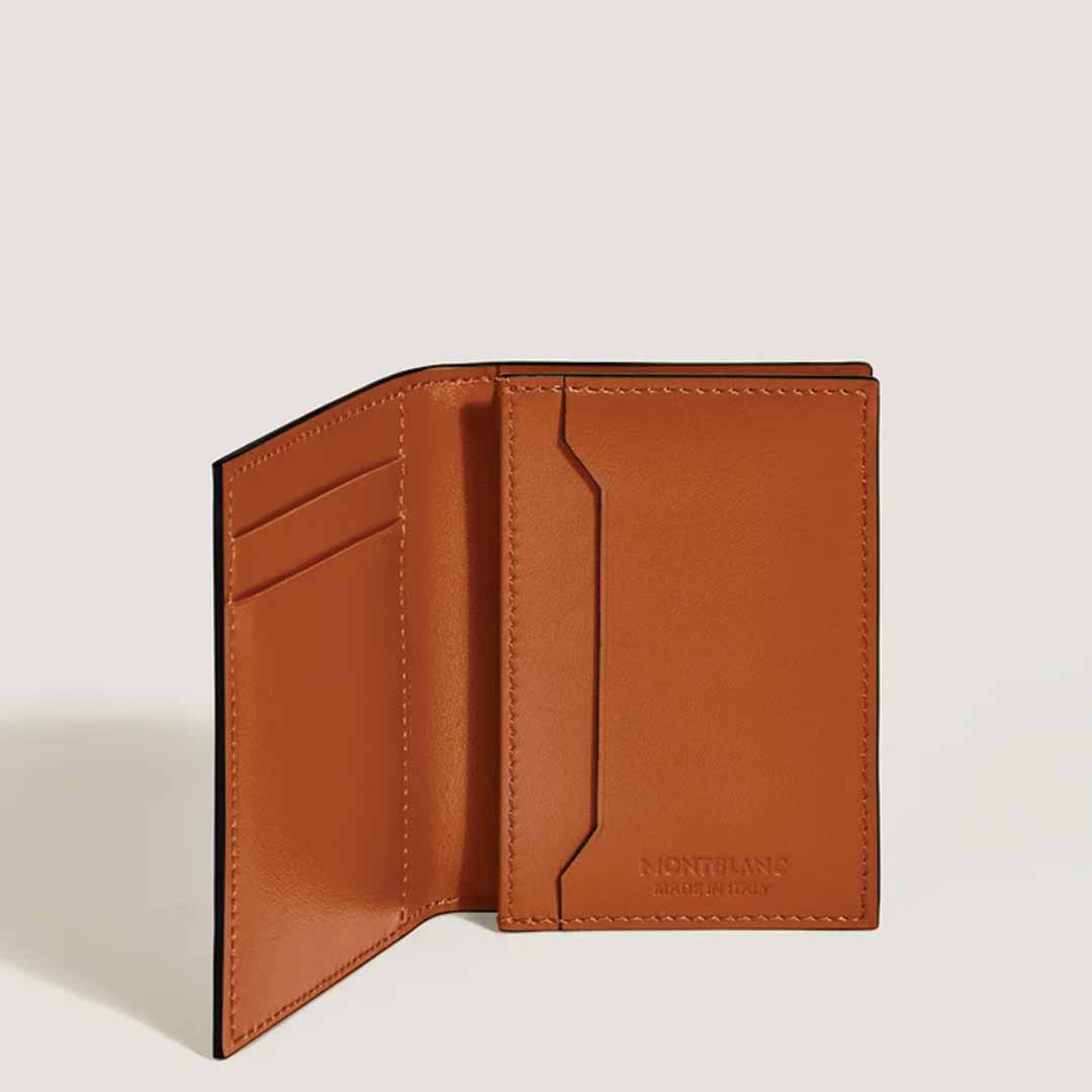 The Montblanc Meisterstück 4cc Leather Card Holder in tan leather features multiple slots and proudly displays its interior. The iconic Montblanc emblem and "Made in Italy" are elegantly embossed inside. This exquisite piece from Montblanc is set against a plain background, epitomizing timeless sophistication.