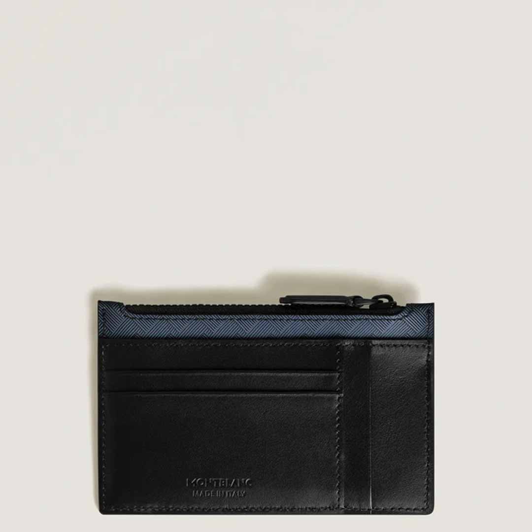A Montblanc Extreme 3.0 leather card holder with a zipped pocket sits elegantly on a plain white background. This sleek black embossed accessory showcases multiple card slots and discreet text at the bottom, while a dark blue trim adds a chic touch to the top edge, embodying its sophisticated design sensibility.