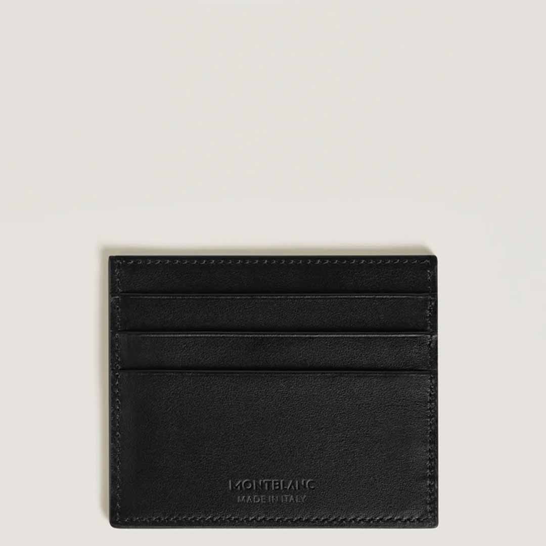 A Montblanc Extreme 3.0 6cc leather card holder, crafted from black full-grain leather with three card slots and the Montblanc brand name embossed at the bottom, is arranged on a light gray background to showcase its stylish and functional design.