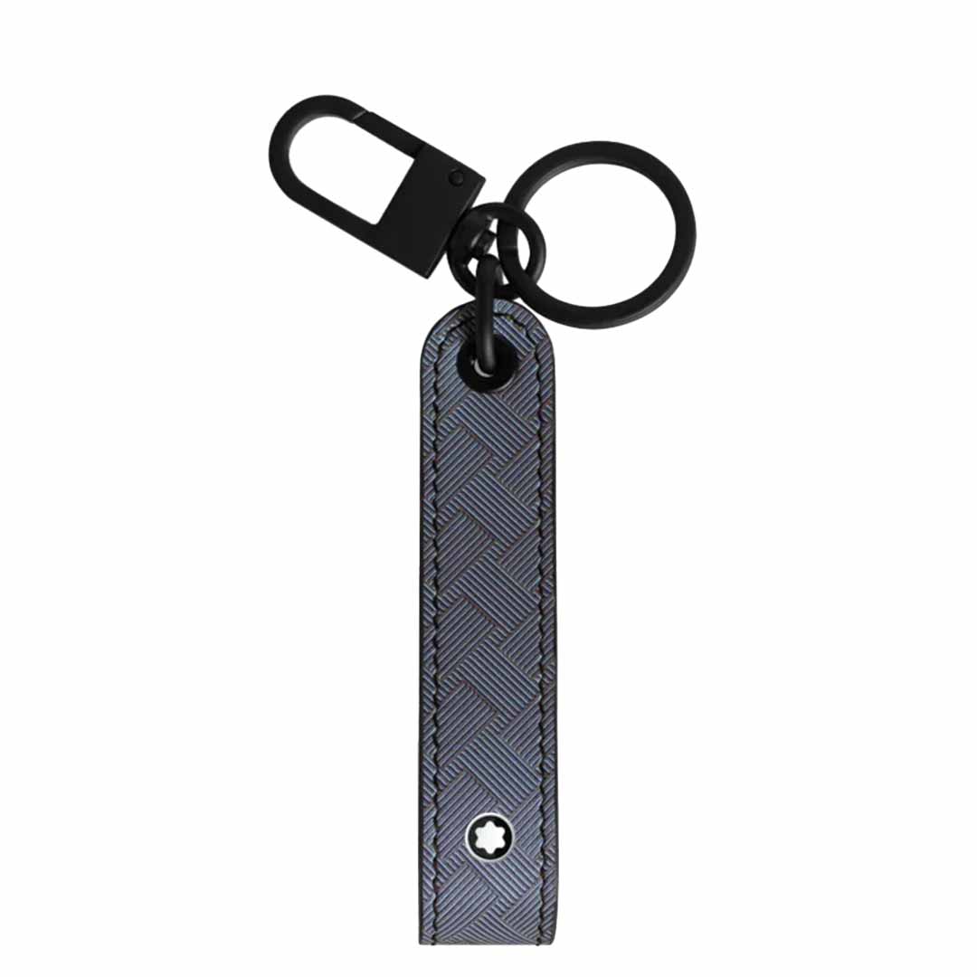 Introducing the Montblanc Extreme 3.0 Black Key FOB, a sleek and fashionable accessory from Montblanc. It showcases a black clip and circular ring, complemented by a textured full-grain bovine leather strap adorned with a subtle geometric pattern and finished with an elegant star-like emblem at the bottom—perfect for elevating your daily essentials.